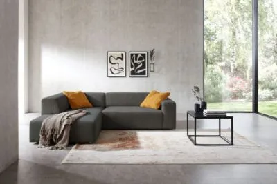 Ecksofa im Trendstoff Cord mit elektrischem Sitzvorzug mgl.