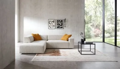 Ecksofa im Trendstoff Cord mit elektrischem Sitzvorzug mgl.